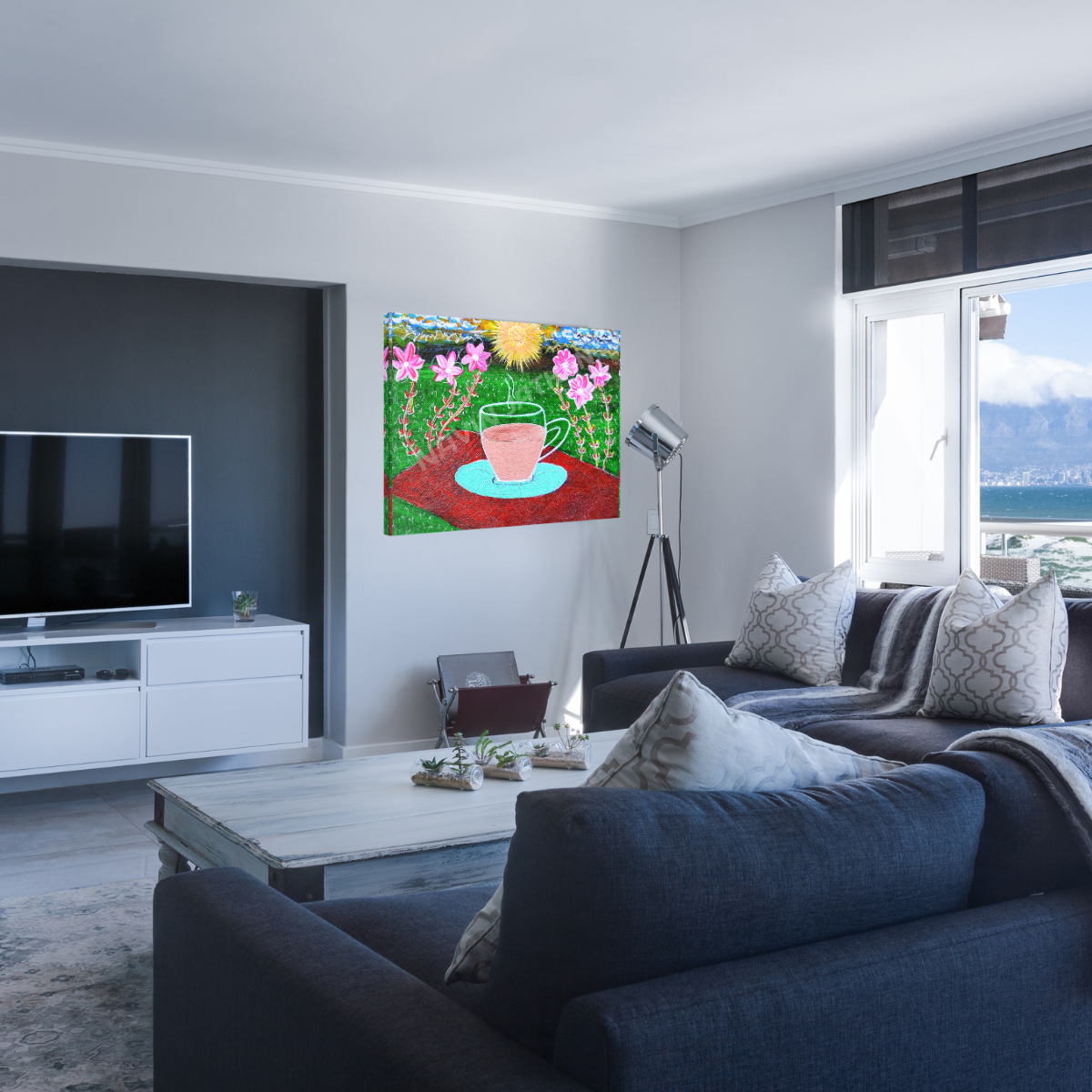 Modern living room with a painting of flowers and a teacup on the wall.