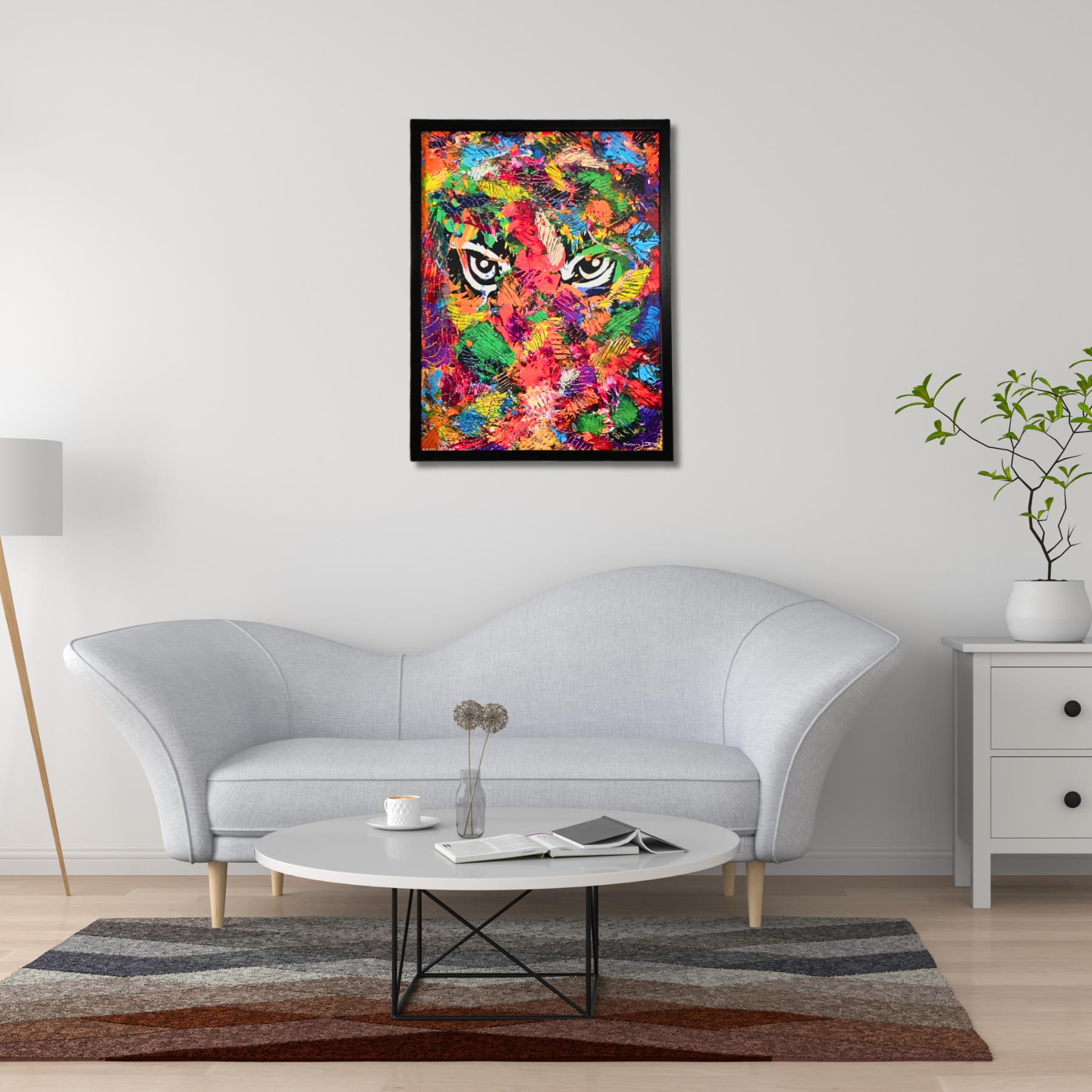 Colorful abstract painting of tiger's face on a wall above a white sofa in a living room.