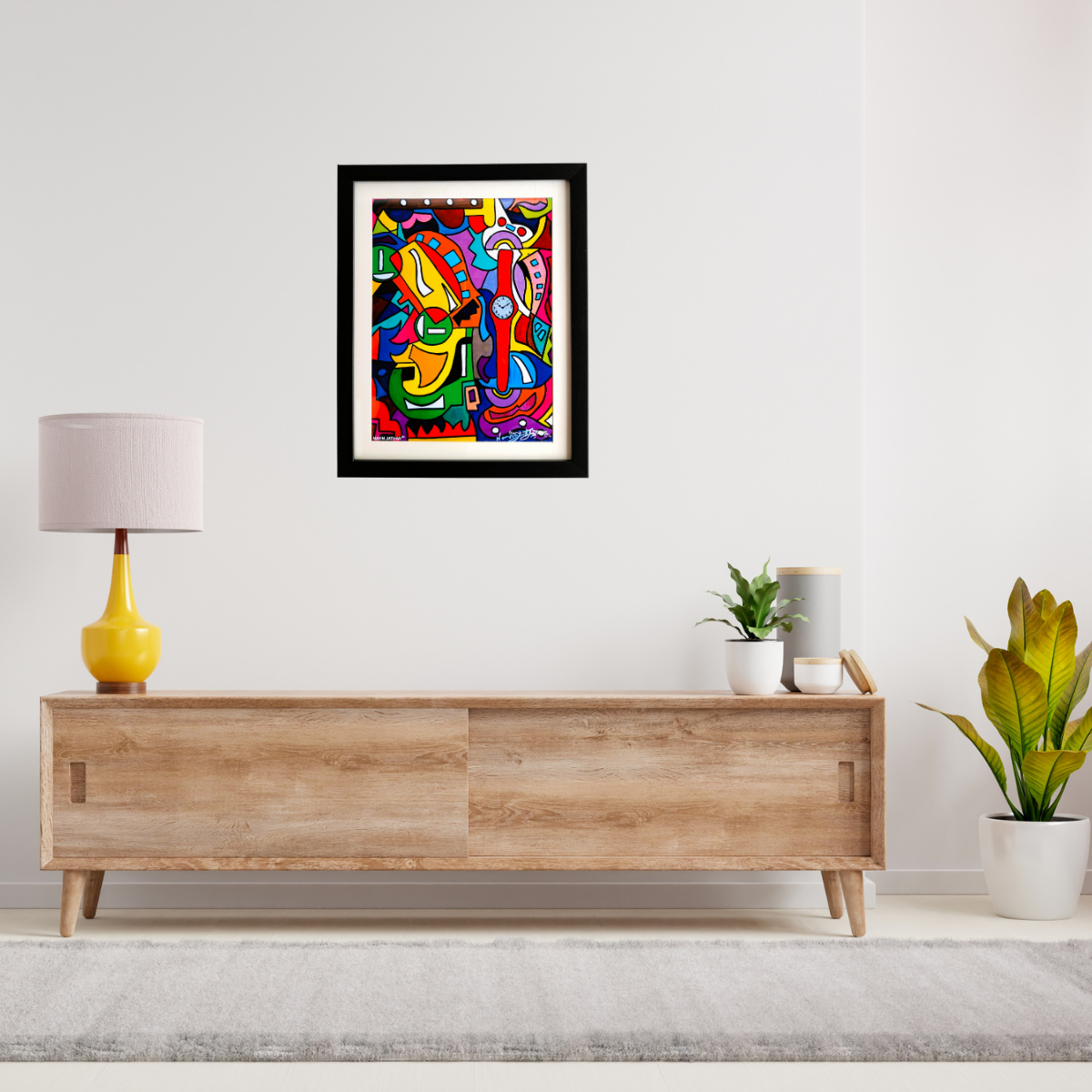 Colorful abstract painting on a wall above a wooden console table with decor items.