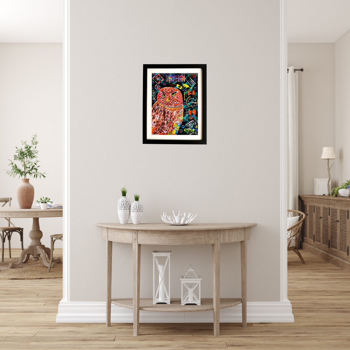 Framed colorful abstract art piece of owlmon a wall in a home setting.